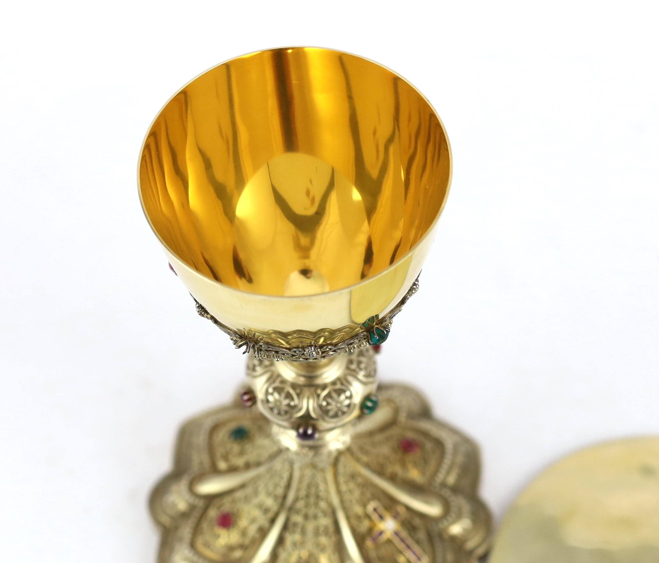 A late 19th/early 20th century American Eucharistic 14kt gold, silver gilt and multi coloured paste set chalice by Benziger Brothers, New York